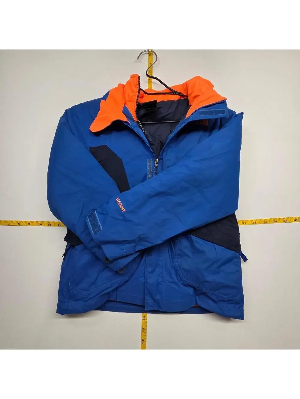The North Face blue & orange kids puffer jacket with navy blue panels, size 7/8